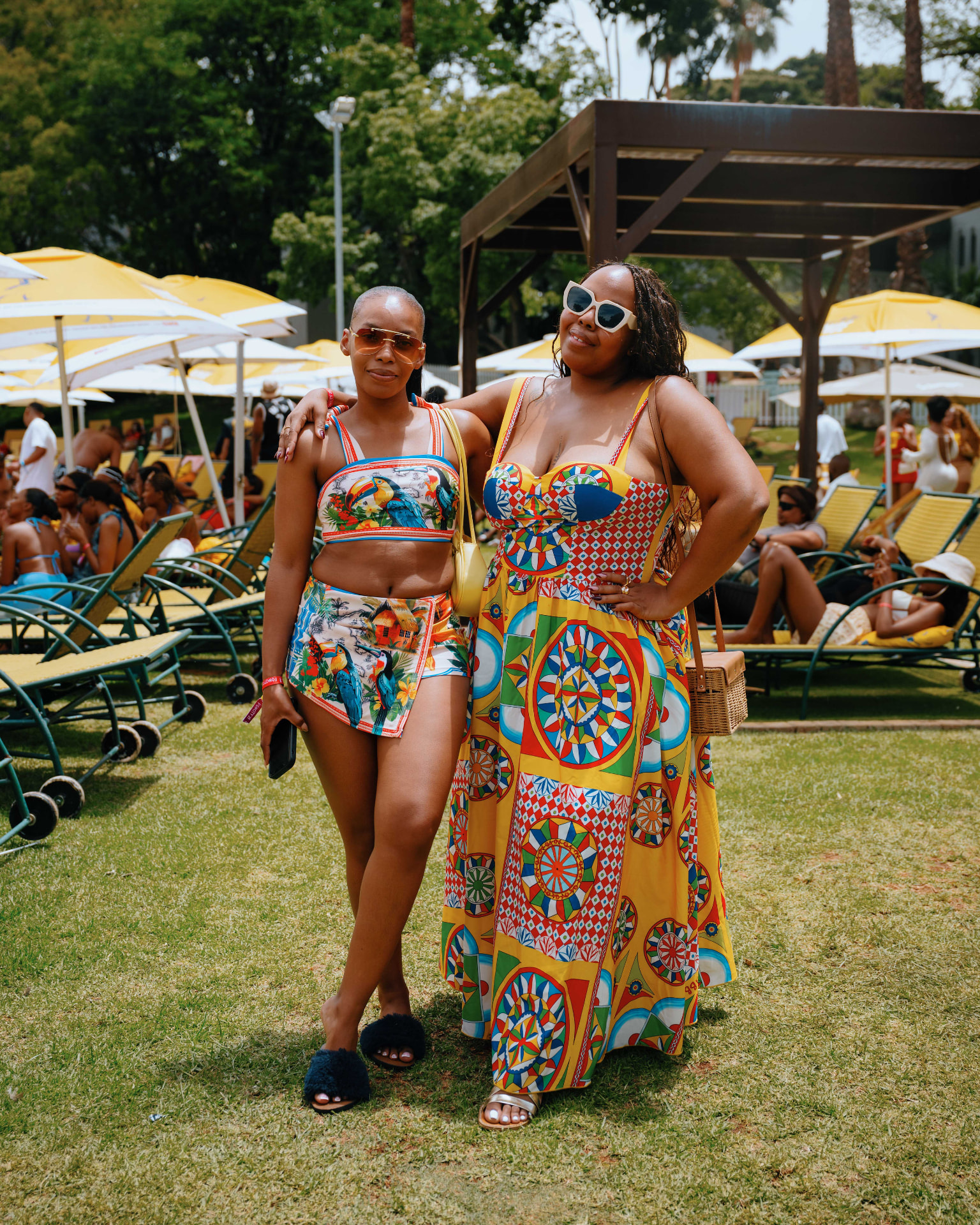 Guests in colourful outfits on the resort lawn