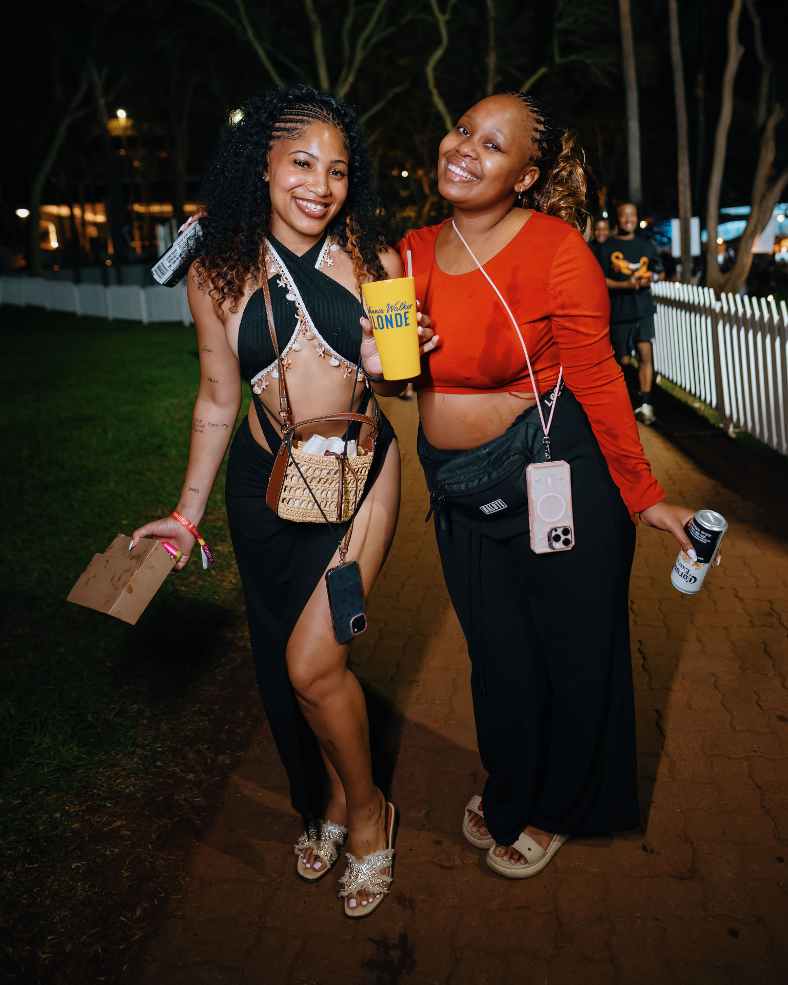 Two guests smiling together at the evening event